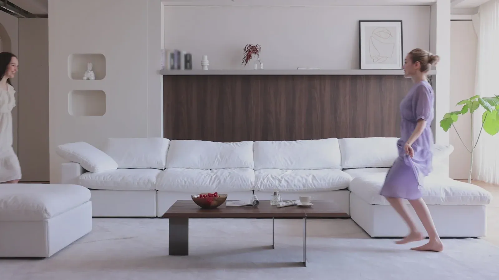 A white Deluxe Cloud sectional in a bright living room